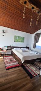 a bedroom with a large bed and a wooden ceiling at Cabana Bujor de Munte in Râşnov