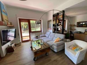 a living room with a couch and a tv at Francigena house in Rome