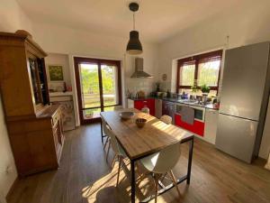 a kitchen with a wooden table with chairs in it at Francigena house in Rome