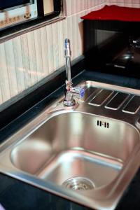 a silver sink in a kitchen next to a counter at Kilimanjaro poa in Moshi