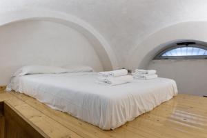 a white bed in a room with a window at Apt Urbana 156 - Monti in Rome