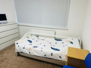 a childs bedroom with a bed and a dresser at Large guest Room in Maidenhead