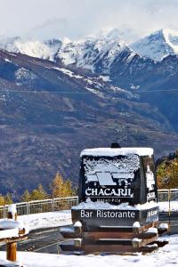 a bus parked on a road with snow on its at Hotel Chacaril in Pila