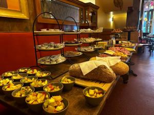 a buffet of food on a table in a restaurant at Hotel Miss Blanche in Groningen