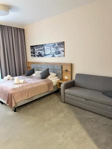 a bedroom with a bed and a couch at RentResidence apartament in Sienna