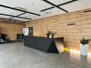 an office lobby with a reception desk and chairs at RentResidence apartament in Sienna