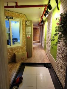a hallway of a building with a door and a window at Halla Livingtel in Goyang