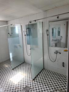 a bathroom with two glass showers and a sink at Halla Livingtel in Goyang