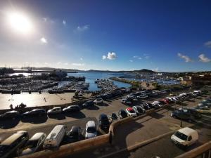 a parking lot filled with parked cars next to the water at Puteoli Sea View in Pozzuoli