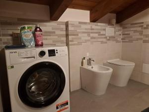 a laundry room with a washing machine and a sink at CASA FIORENTINI CESENATICO in Cesenatico