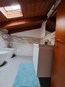 a bathroom with two toilets and a blue rug at CASA FIORENTINI CESENATICO in Cesenatico