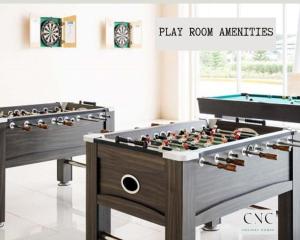 a set of four foosball tables in a room at CNC Tagaytay Staycation with Netflix in Tagaytay