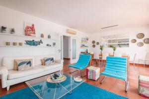 uma sala de estar com um sofá branco e cadeiras azuis em Prainha Sunny 5BR Villa (up to 13 guests) em Alvor