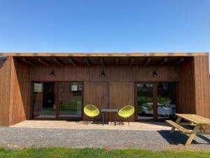 a building with two yellow chairs and a table at A Quinta de Bouzas in Mazaricos