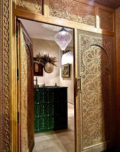 an entrance to a room with a green cabinet and a door at Riad Diamond Of Marrakech in Marrakech