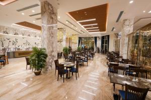 jadalnia ze stołami i krzesłami w restauracji w obiekcie Helnan Mamoura Hotel & Events Center w Aleksandrii