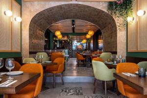 a restaurant with tables and chairs and a brick wall at Studio apartment with kitchenette at the new Olo living in Paceville