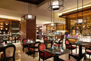 a restaurant with tables and chairs and a bar at InterContinental Changsha by IHG in Changsha