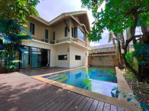 a house with a swimming pool in front of it at Baan Natcha Villa in Pattaya Central