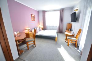 Postel nebo postele na pokoji v ubytování Hotel Trzy Światy Spa & Wellness Rajska WySpa