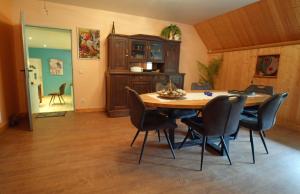 a dining room with a table and chairs at Apartment in old farmhouse in Bockholtz