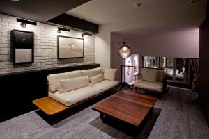 a living room with a couch and a coffee table at Hotel Risveglio Akasaka in Tokyo