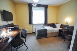 Postel nebo postele na pokoji v ubytování Hotel Trzy Światy Spa & Wellness Rajska WySpa