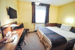 Postel nebo postele na pokoji v ubytování Hotel Trzy Światy Spa & Wellness Rajska WySpa