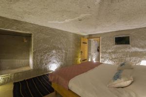 Postel nebo postele na pokoji v ubytování My Cave Suites