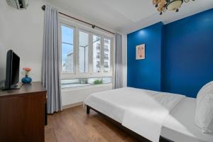 Postel nebo postele na pokoji v ubytování Gold Time Hotel Da Nang