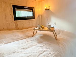 a bedroom with a bed with a table on it at Camping de Vinkenkamp in Lieren
