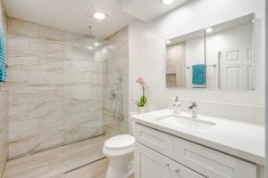 a bathroom with a toilet and a sink and a shower at Wai Lani in Princeville +31 photos