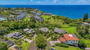 an aerial view of a house on a hill next to the ocean at Wai Lani in Princeville