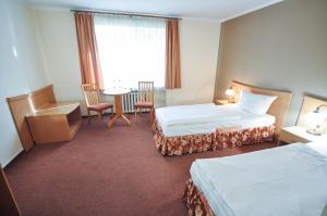 Postel nebo postele na pokoji v ubytování Hotel Trzy Światy Spa & Wellness Rajska WySpa