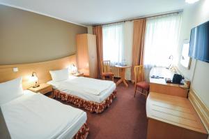 Postel nebo postele na pokoji v ubytování Hotel Trzy Światy Spa & Wellness Rajska WySpa