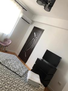 a bedroom with a bed with a black door at Studio Central Doamnei in Bucharest