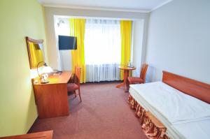 Postel nebo postele na pokoji v ubytování Hotel Trzy Światy Spa & Wellness Rajska WySpa