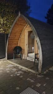 a gazebo with a bench and a chair in it at Stressless aktivCARD Bayerischer Wald inklusive in Sankt Englmar