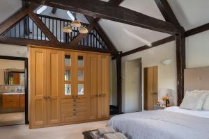 a bedroom with a bed and a large wooden closet at Lake House in Brecon
