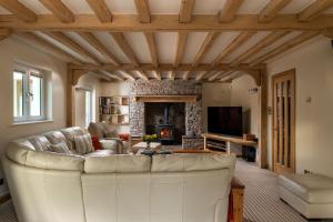 a living room with a couch and a fireplace at Lake House in Brecon