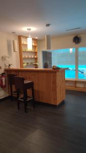 a room with a bar with a table and a chair at Stressless aktivCARD Bayerischer Wald inklusive in Sankt Englmar
