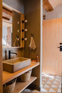 a bathroom with a sink and a mirror at Hotel-Masia Can Farrés in El Bruc