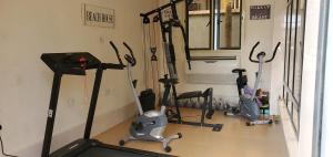 a gym with several exercise bikes in a room at 3TS LUXURY APARTMENTS in Sangotedo