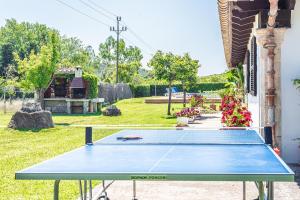 a blue ping pong table in a yard at Villa ANGELS in Pollença