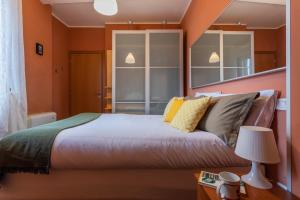 a bedroom with a large bed with orange walls at Sui tetti di Torino by Wonderful Italy in Turin