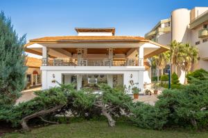 a large white building with trees in front of it at Adora Hotel & Resort in Belek