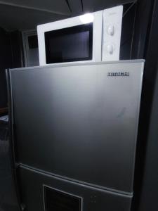 a microwave oven sitting on top of a refrigerator at Tempo Inn West Kowloon HSR Station in Hong Kong