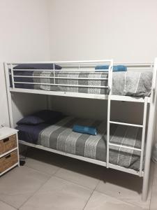 a bunk bed with towels and a mattress at Hostel-Style GUESTHOUSE - for 18-35yrs in Caloundra