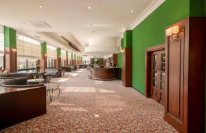 a hotel lobby with green walls and a waiting area at Adora Hotel & Resort in Belek +114 photos