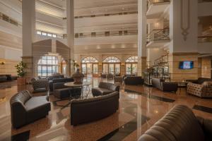 a lobby with couches and tables in a building at Adora Hotel & Resort in Belek